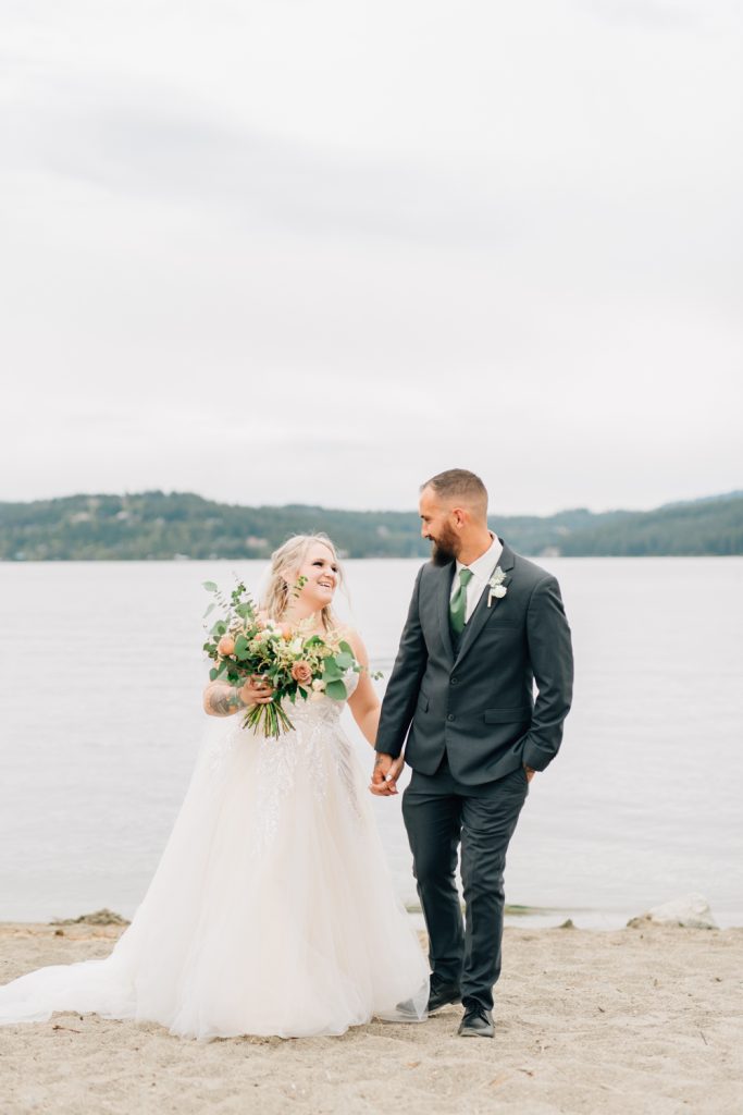 _A1S9485 Bride and groom wedding photography walking on the beach at lake Coeur d'Alene Idaho