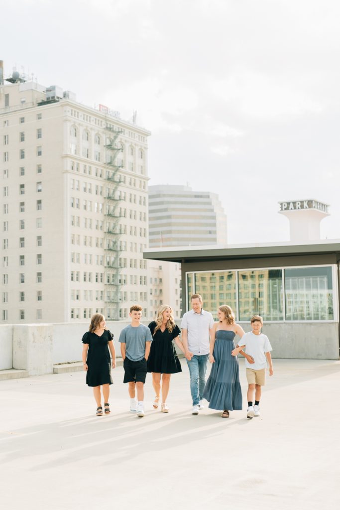 _A1S6005 A family walking on the rooftop of the grand hotel in spokane wa during their urban photoshoot.