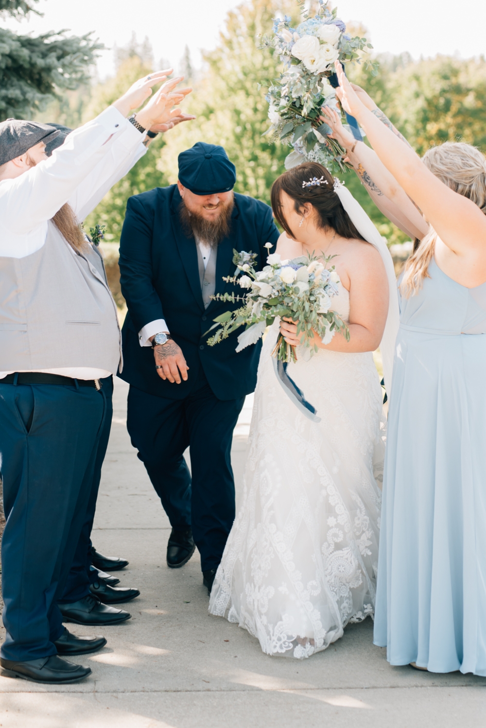 coeur d'alene light and airy wedding photography, Riverstone park, bride and groom running through wedding party tunnel